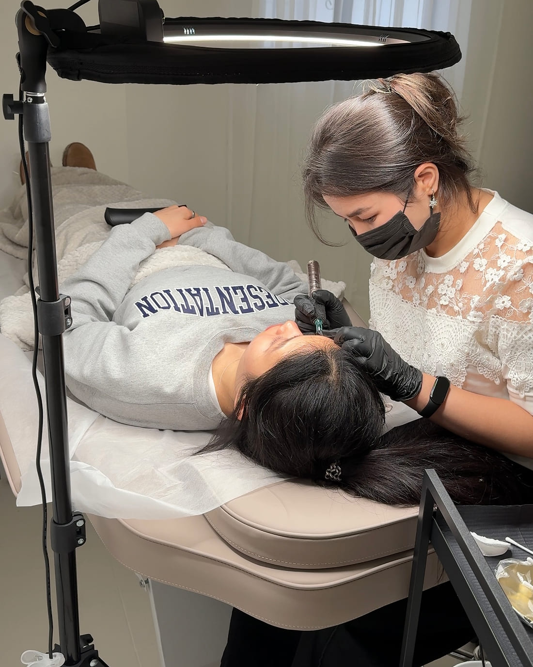 Naz working on a client in the private treatment room at Lumière Beauty Atelier
